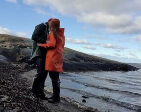 Cuddling in Rainwear on the Beach