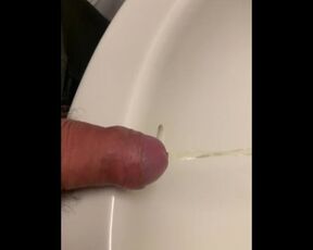 Close up dick peeing in sink